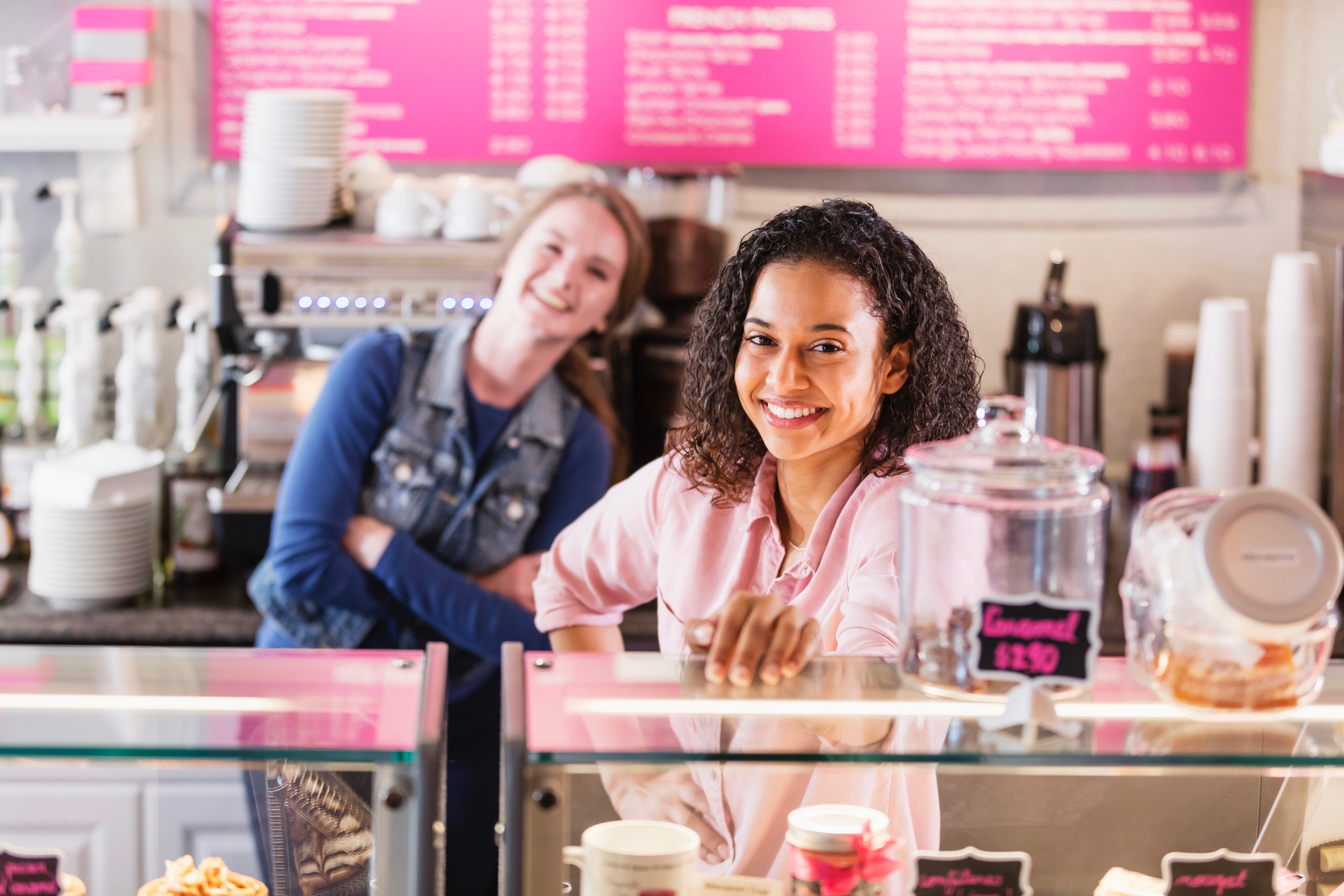 Franchise owners behind the counter of a pastry shop