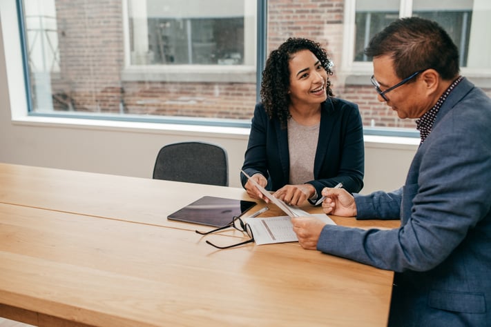 Lawyer speaks with her client in an office